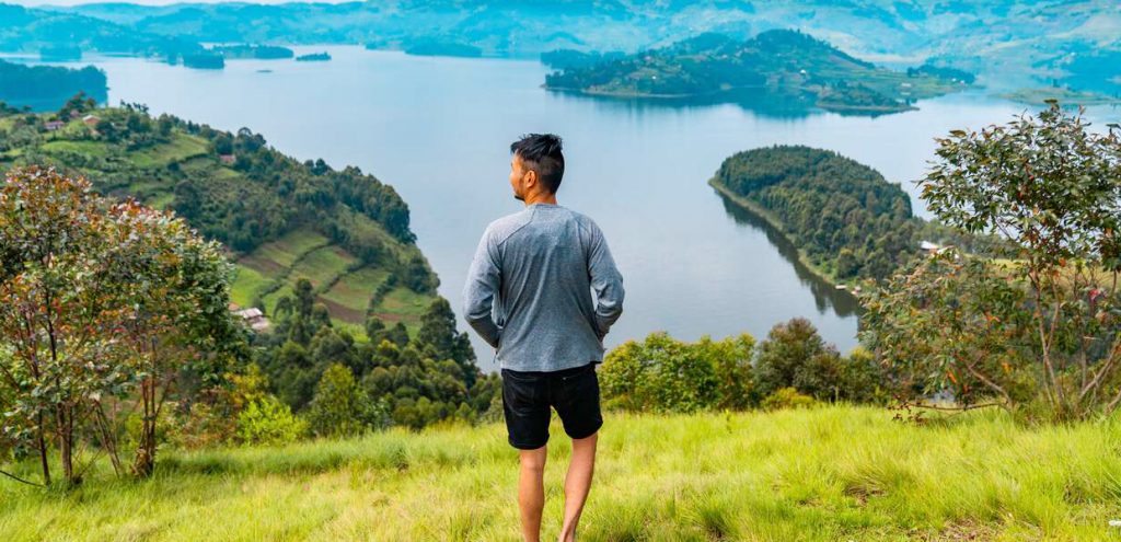 A visitor enjoying the picturesque Lake Bunyonyi. Credit: bucketlistly.blog